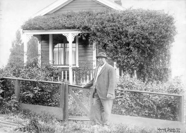 Joe Fortes in front of his cottage at the foot of Bidwell Street (1700 Beach Avenue). Photo reproduced in 1922. Vancouver Archives # CVA 371-1977.