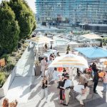 Guests gathering outside and drinking at the Veuve Clicquot Aqua Lounge