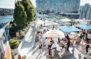 Guests gathering outside and drinking at the Veuve Clicquot Aqua Lounge