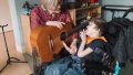 Photo caption: Karin Roberts, Canuck Place Music Therapist, with Owen Hill-Davie, Canuck Place Child