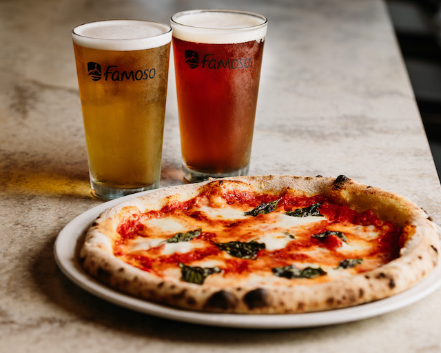 Famoso homemade margherita pizza and two beers shown