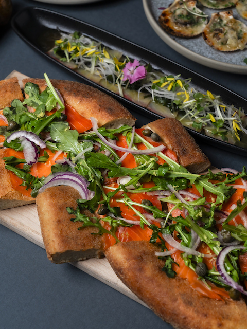 Coast Happy Hour pizza with capers, arugula and red onion, Nora Hamade