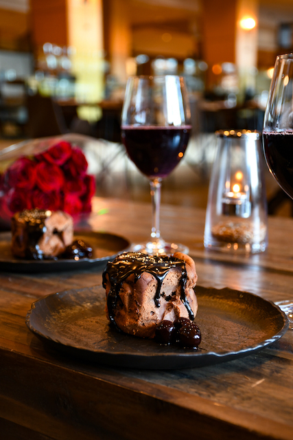 H2 Kitchen and Bar's Dark Chocolate Basque Cheesecake with chocolate sauce and paired with red wine