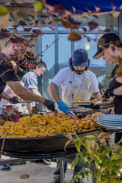 Como Taperia and Paella Guys cooking on patio in large grill