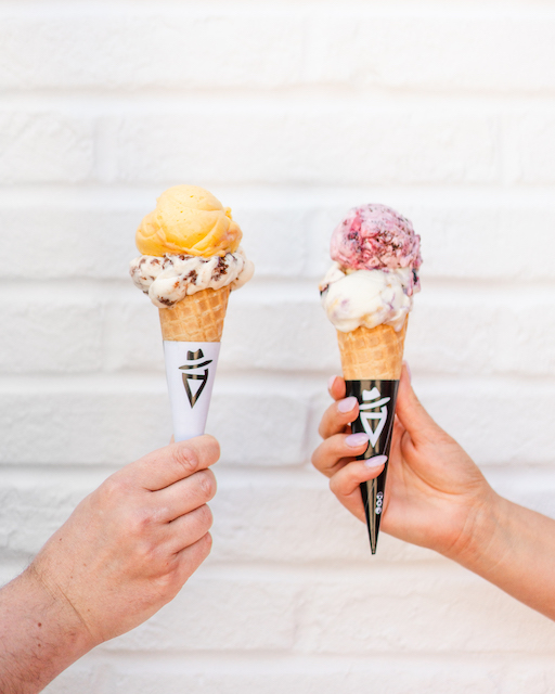 Two gelato cones being held from Dolce Amore