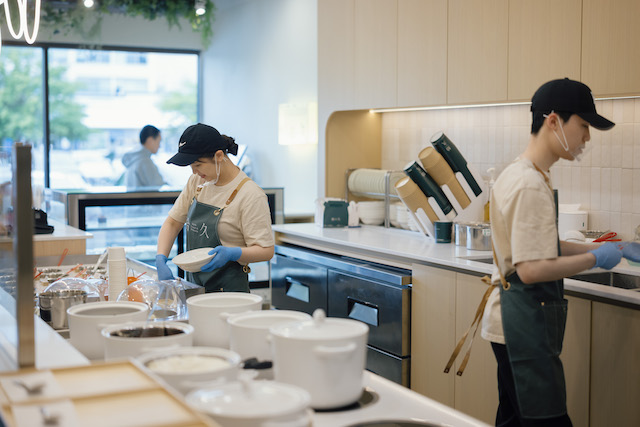 Myth Dessert & Patisserie employees behind counter making treats